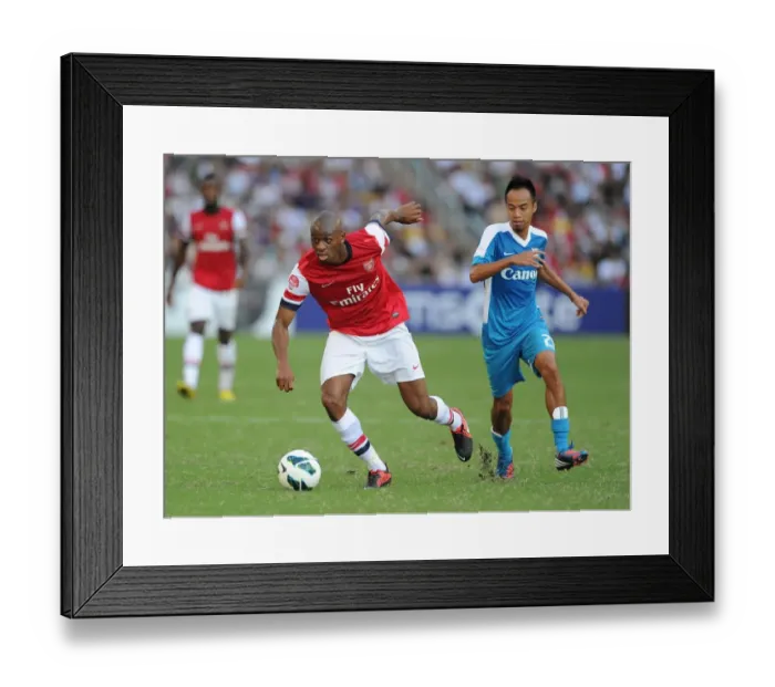 Framed Print : Abou Diaby Outmaneuvers Cheng Siu Wai: Kitchee FC vs. Arsenal FC, 2012