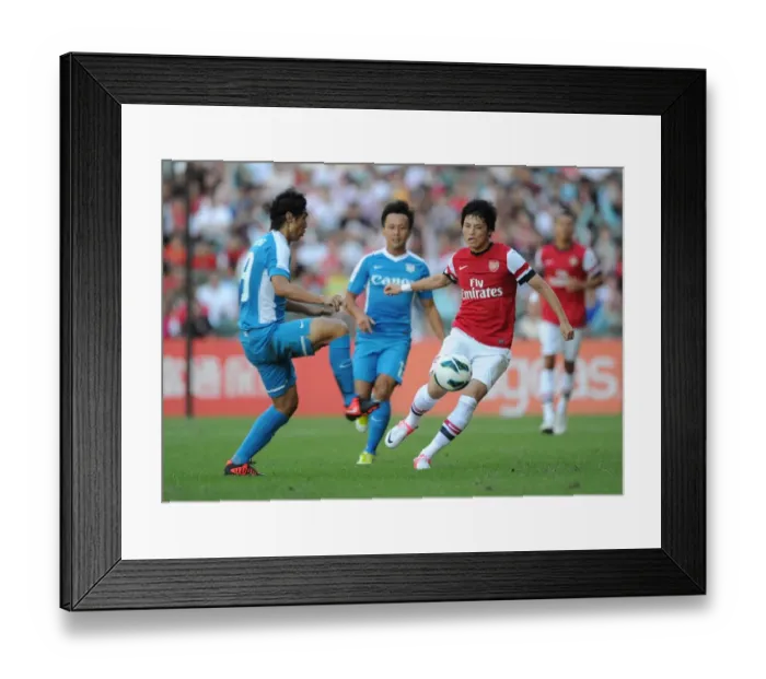 Framed Print : Ryo Miyaichi vs Jorge Paramo: Clash of Stars in Kitchee FC vs Arsenal FC Pre-Season Friendly