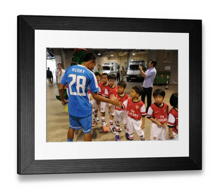 Framed Print : Player Escorts Align before Kitchee FC vs. Arsenal FC Match, 2012