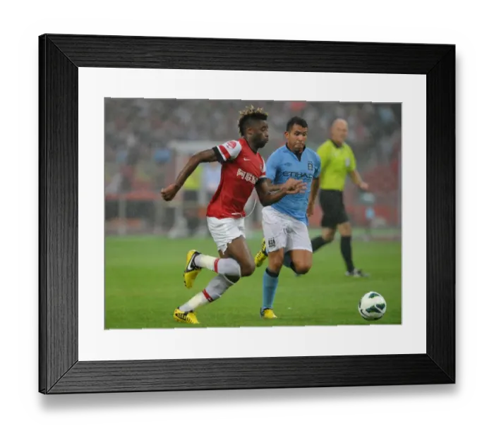 Framed Print : Clash of Titans: Alex Song vs. Carlos Tevez - Arsenal FC vs. Manchester City