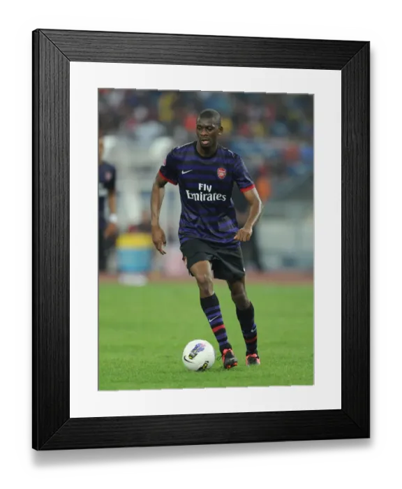 Framed Print : Abou Diaby in Action: Arsenal vs Malaysia XI (2012) Framed Print : Abou Diaby in Action: Arsenal vs Malaysia XI (2012)