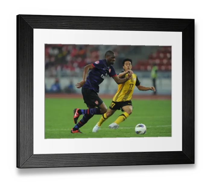 Framed Print : Abou Diaby vs Mohd Shakir Shaari: Clash of the Stars in Arsenal's 2012 Pre-Season Match against Malaysia XI Framed Print : Abou Diaby vs Mohd Shakir Shaari: Clash of the Stars in Arsenal's 2012 Pre-Season Match against Malaysia XI