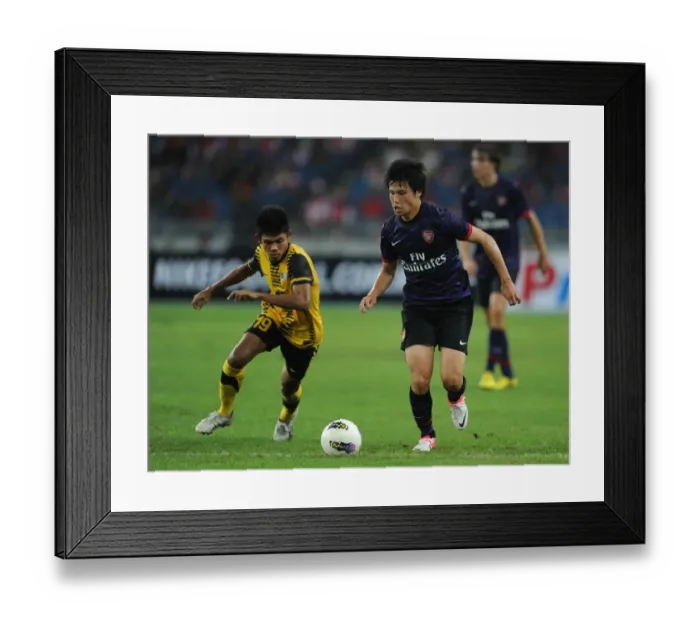 Framed Print : Ryo Miyaichi vs Ahmad Shakir Md Ali: A Football Showdown in the 2012-13 Arsenal Pre-Season Match in Malaysia Framed Print : Ryo Miyaichi vs Ahmad Shakir Md Ali: A Football Showdown in the 2012-13 Arsenal Pre-Season Match in Malaysia