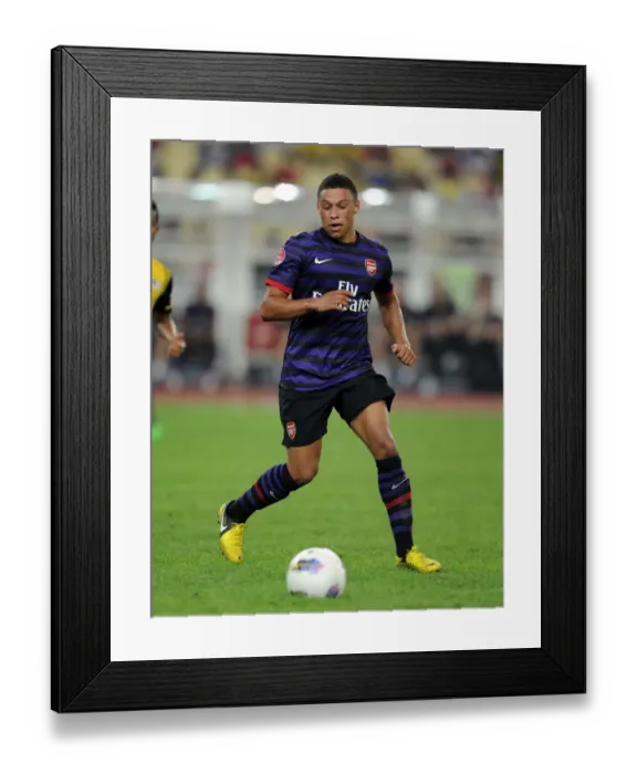 Framed Print : Alex Oxlade-Chamberlain: In Action for Arsenal Against Malaysia XI (2012-13) Framed Print : Alex Oxlade-Chamberlain: In Action for Arsenal Against Malaysia XI (2012-13)
