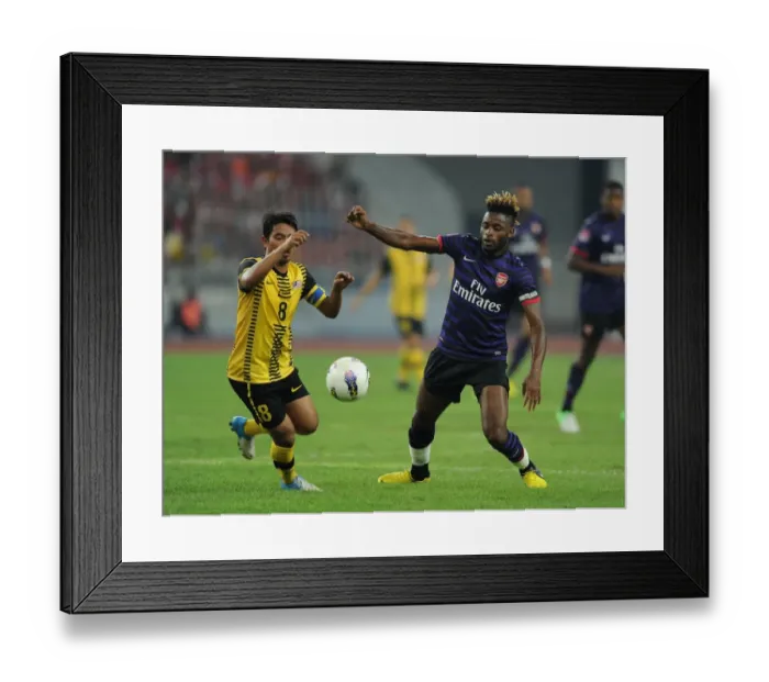 Framed Print : Clash of Talents: Alex Song vs. Safiq Bin Rahim (Malaysia XI vs. Arsenal, 2012)