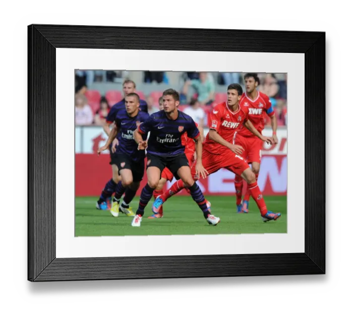 Framed Print : Gervinho vs. Strobl: Arsenal's Pre-Season Clash with FC Cologne (2012)