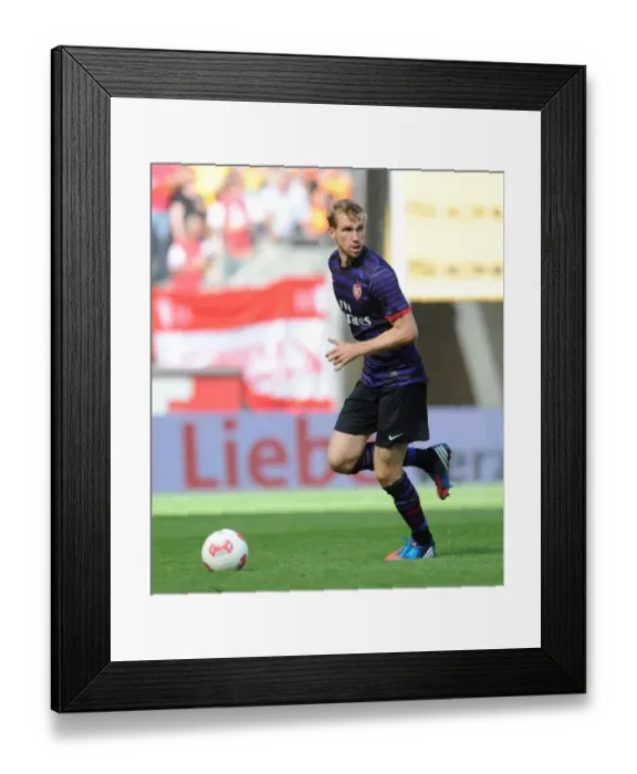 Framed Print : Arsenal's Per Mertesacker Goes Head-to-Head with FC Cologne in 2012 Pre-Season Clash