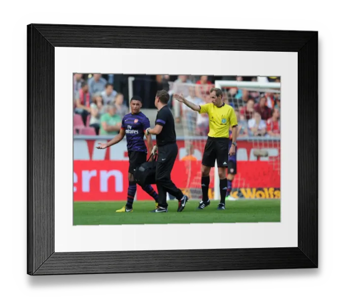 Framed Print : Arsenal's Colin Lewin Tends to Injured Oxlade-Chamberlain in Pre-Season Friendly against Cologne Framed Print : Arsenal's Colin Lewin Tends to Injured Oxlade-Chamberlain in Pre-Season Friendly against Cologne