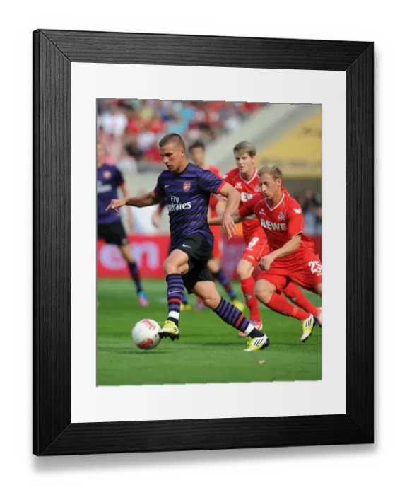 Framed Print : Podolski vs. Royer: Clash of the Forwards in Arsenal's Pre-Season Friendly against Cologne (2012)