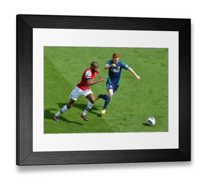 Framed Print : LONDON, ENGLAND - AUGUST 18: Abou Diaby of Arsenal takes on Jack Colback of Sunderland during the Barclays Premier League match between Arsenal and Sunderland at Emirates Stadium on August 18, 2012 in London, England. : Arsenal Football Framed Print : LONDON, ENGLAND - AUGUST 18: Abou Diaby of Arsenal takes on Jack Colback of Sunderland during the Barclays Premier League match between Arsenal and Sunderland at Emirates Stadium on August 18, 2012 in London, England. : Arsenal Football