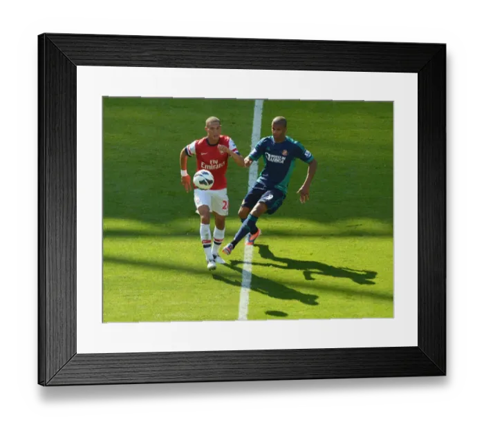 Framed Print : LONDON, ENGLAND - AUGUST 18: Kieran Gibbs of Arsenal takes on Fraizer Campbell of Sunderland during the Barclays Premier League match between Arsenal and Sunderland at Emirates Stadium on August 18, 2012 in London, England. : Arsenal Football