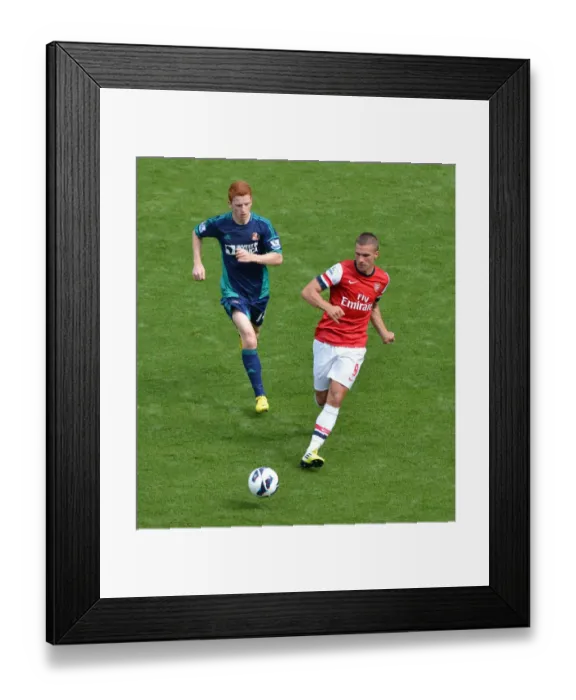 Framed Print : Arsenal's Lukas Podolski Faces Off Against Sunderland's Jack Colback at Emirates Stadium Framed Print : Arsenal's Lukas Podolski Faces Off Against Sunderland's Jack Colback at Emirates Stadium