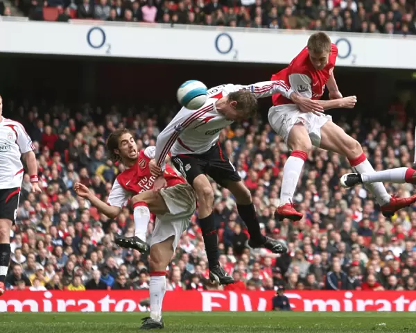 Nicklas Bendtner jumps above Peter Crouch to head in the Arsenal goal