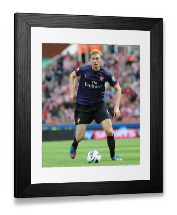 Framed Print : Per Mertesacker Focuses in Stoke City vs Arsenal Premier League Clash (2012-13)