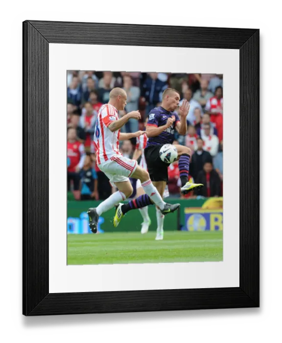 Framed Print : Arsenal's Lukas Podolski Faces Off Against Stoke City's Andy Wilkinson in 2012-13 Premier League Clash