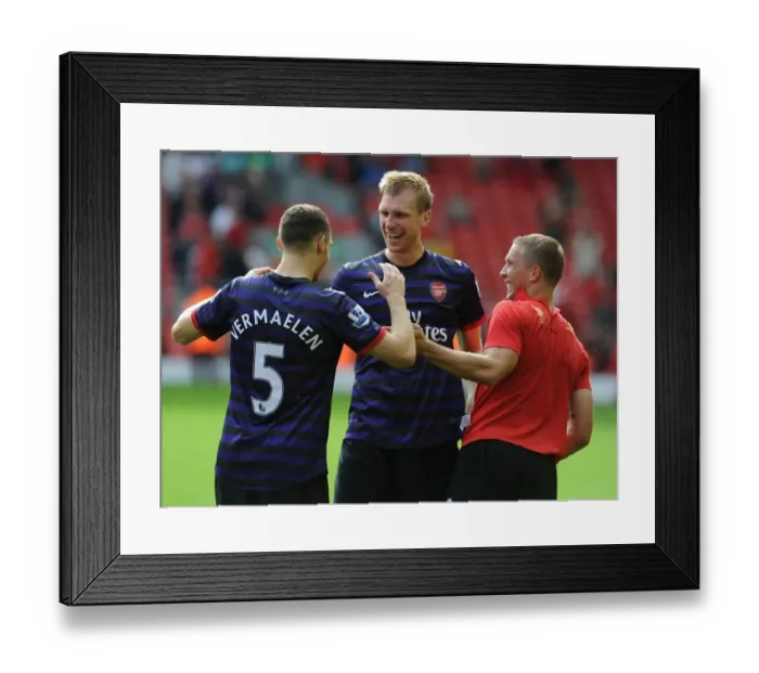 Framed Print : Arsenal's Triumphant Trio: Vermaelen, Mertesacker, Podolski Celebrate Victory at Anfield