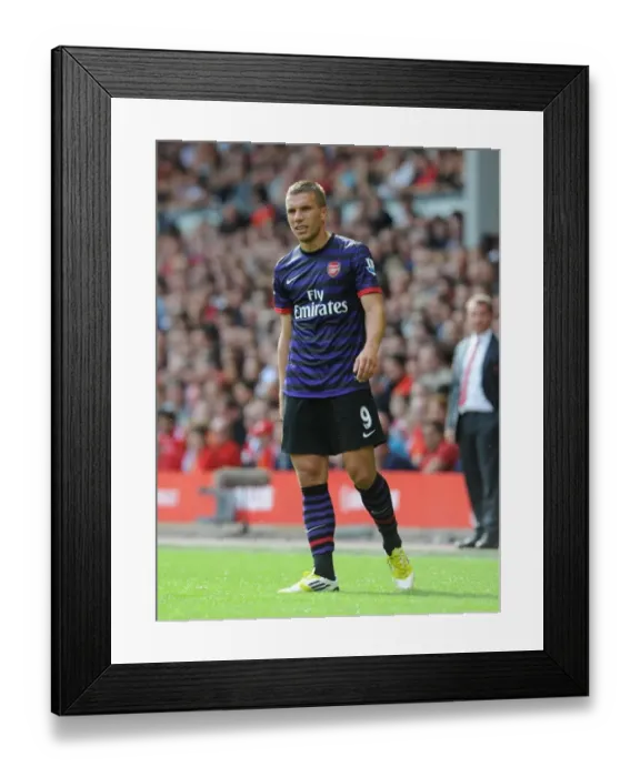 Framed Print : Lukas Podolski Faces Off Against Liverpool in the 2012-13 Premier League