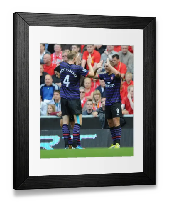 Framed Print : Lukas Podolski and Per Mertesacker Celebrate First Arsenal Goal Against Liverpool (2012-13) Framed Print : Lukas Podolski and Per Mertesacker Celebrate First Arsenal Goal Against Liverpool (2012-13)