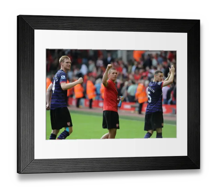 Framed Print : Arsenal's Triumph: Mertesacker, Podolski, and Vermaelen's Victory Dance (Liverpool 2012)