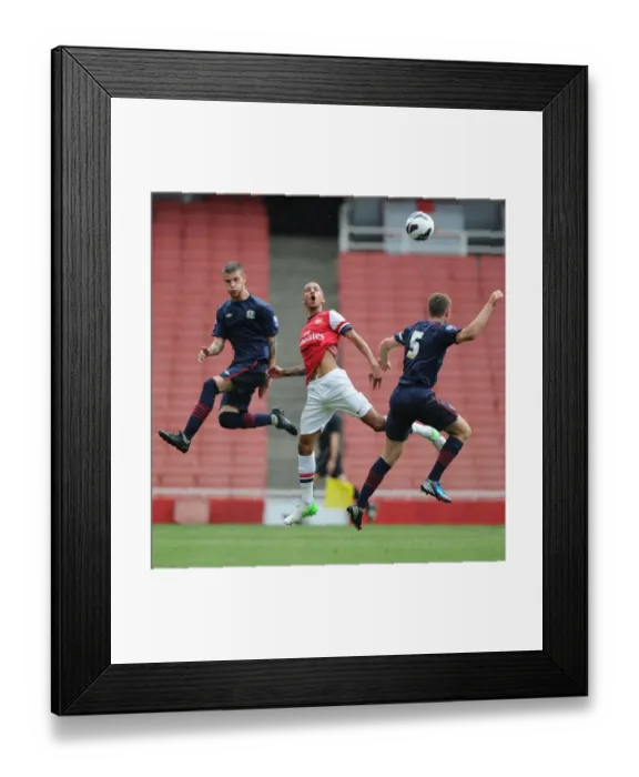 Framed Print : Intense Rivalry: Craig Eastmond's Leap Over Molina and O'Connell during Arsenal U21s vs Blackburn Rovers Framed Print : Intense Rivalry: Craig Eastmond's Leap Over Molina and O'Connell during Arsenal U21s vs Blackburn Rovers