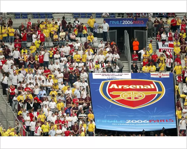 Arsenal fans near a giant Arsenal crest