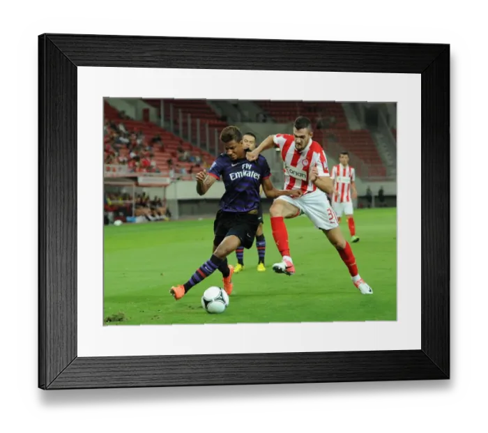 Framed Print : Angha vs. Lykogiannis: Tense Moment in Olympiacos vs. Arsenal NextGen Series Match