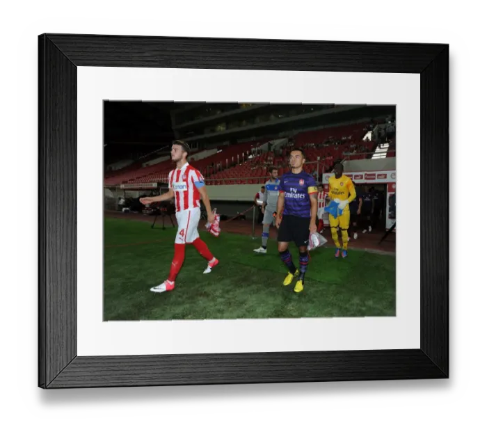 Framed Print : Nico Yennaris and Konstantinos Rougkalas Lead Out Teams at Olympiacos vs. Arsenal NextGen Series Match