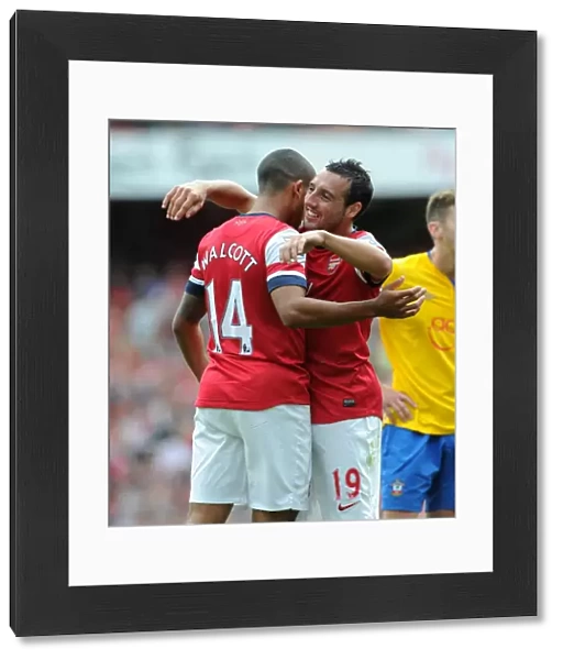 Theo Walcott celebrates scoring the 6th Arsenal goal with Santi Cazorla