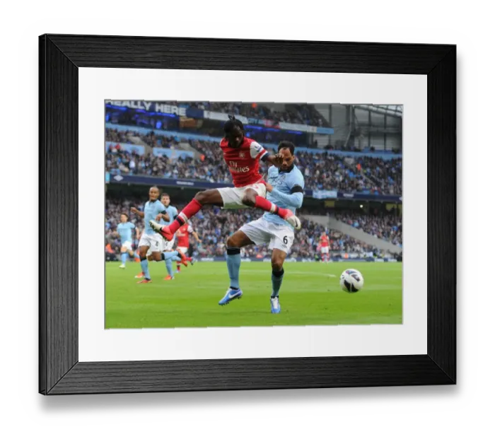 Framed Print : Gervinho vs. Joleon Lescott: Manchester City vs. Arsenal, Premier League Showdown (2012)