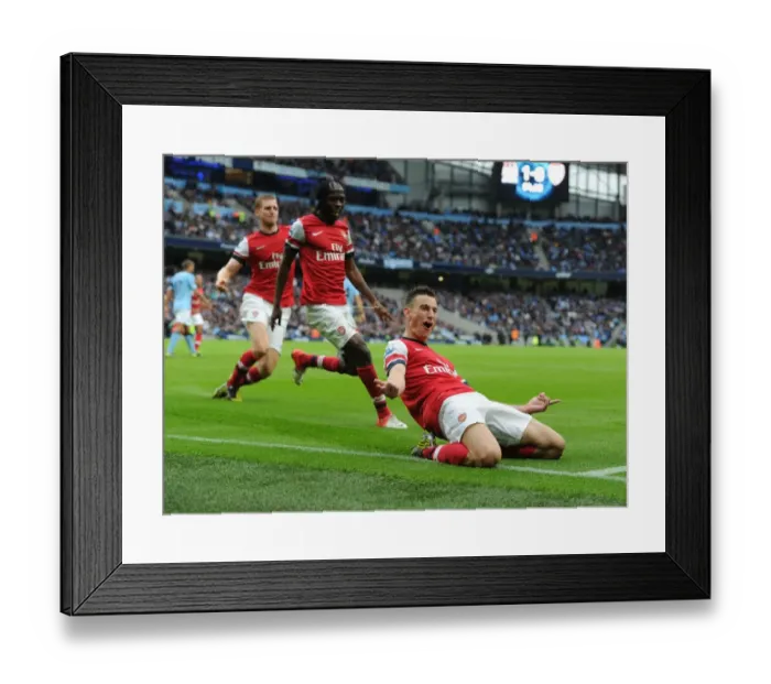 Framed Print : Arsenal's Triumph: Koscielny, Mertesacker, and Gervinho Celebrate Goal Against Manchester City (2012-13) Framed Print : Arsenal's Triumph: Koscielny, Mertesacker, and Gervinho Celebrate Goal Against Manchester City (2012-13)