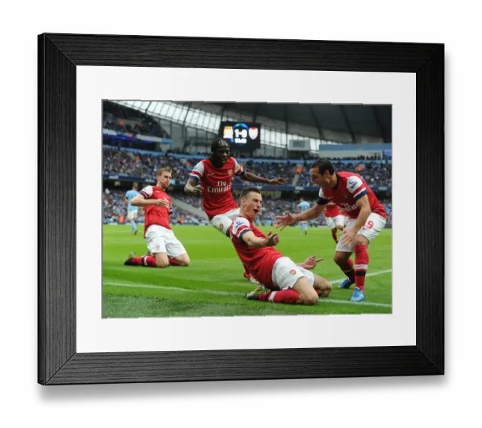 Framed Print : Arsenal's Unforgettable Victory: Koscielny, Gervinho, Cazorla, and Mertesacker Celebrate Goal Against Manchester City (2012-13)