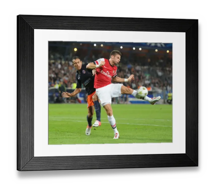 Framed Print : Giroud vs Hilton: Intense Battle in Montpellier v Arsenal UEFA Champions League Clash