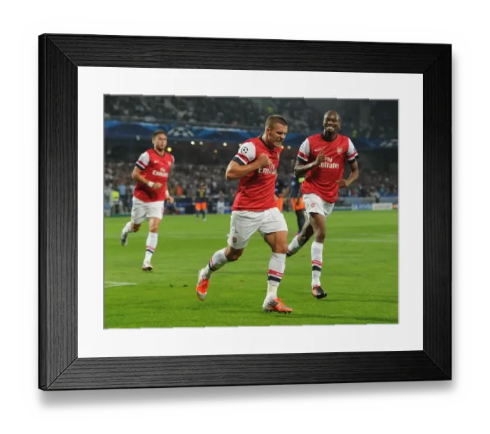 Framed Print : Podolski and Diaby Celebrate Arsenal's First Goal vs Montpellier (2012-13 Champions League)