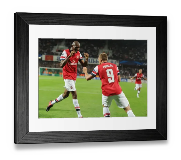 Framed Print : Lukas Podolski and Abou Diaby Celebrate Arsenal's First Goal Against Montpellier (2012-13)