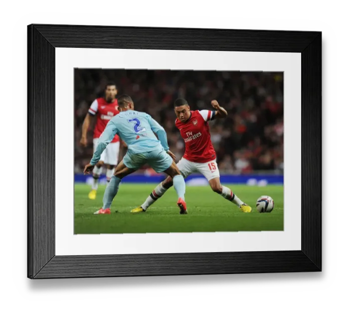 Framed Print : Arsenal's Alex Oxlade-Chamberlain Faces Off Against Coventry's Jordan Clarke in Capital One Cup Clash Framed Print : Arsenal's Alex Oxlade-Chamberlain Faces Off Against Coventry's Jordan Clarke in Capital One Cup Clash