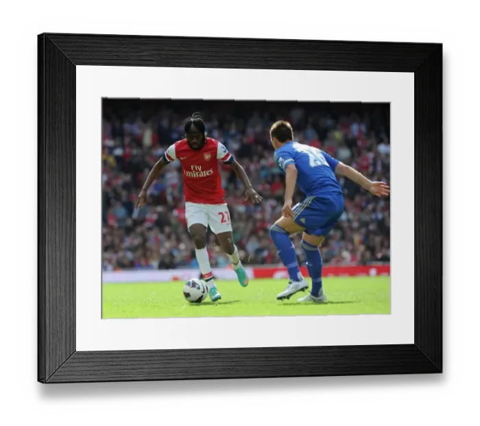 Framed Print : Gervinho vs John Terry: Intense Rivalry at the Emirates - Arsenal v Chelsea (2012-13)