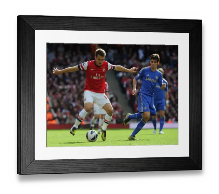 Framed Print : Arsenal's Ramsey Clashes with Chelsea's Oscar in Premier League Showdown