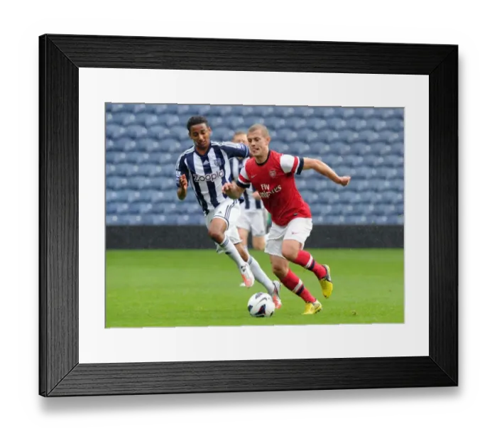 Framed Print : Clash of the Young Stars: Jack Wilshere vs Mani O'Sullivan in Arsenal's U21 Triumph over West Bromwich Albion