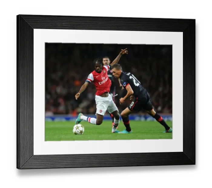 Framed Print : Arsenal's Gervinho Clashes with Olympiacos Jose Holebas in Champions League Showdown