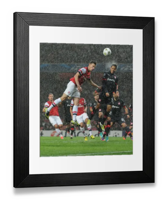 Framed Print : Arsenal vs. Olympiacos: Koscielny vs. Fuster in Champions League Clash Framed Print : Arsenal vs. Olympiacos: Koscielny vs. Fuster in Champions League Clash