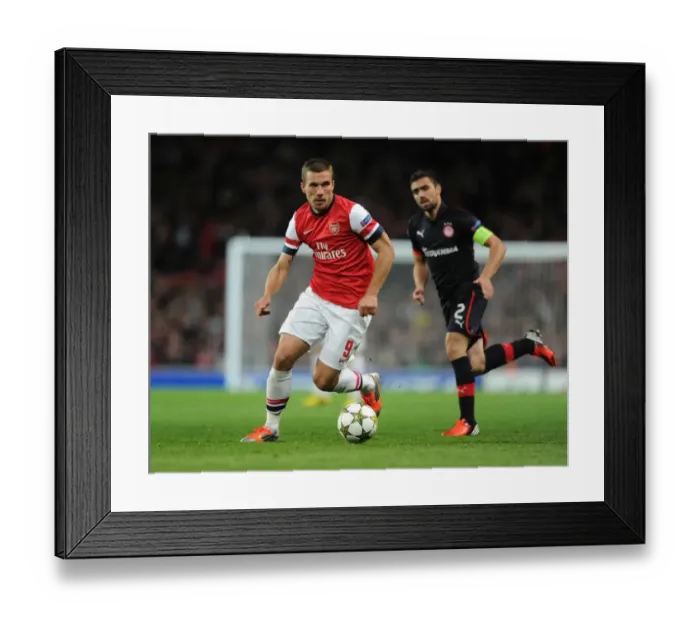 Framed Print : Lukas Podolski in Action for Arsenal against Olympiacos, UEFA Champions League 2012-13