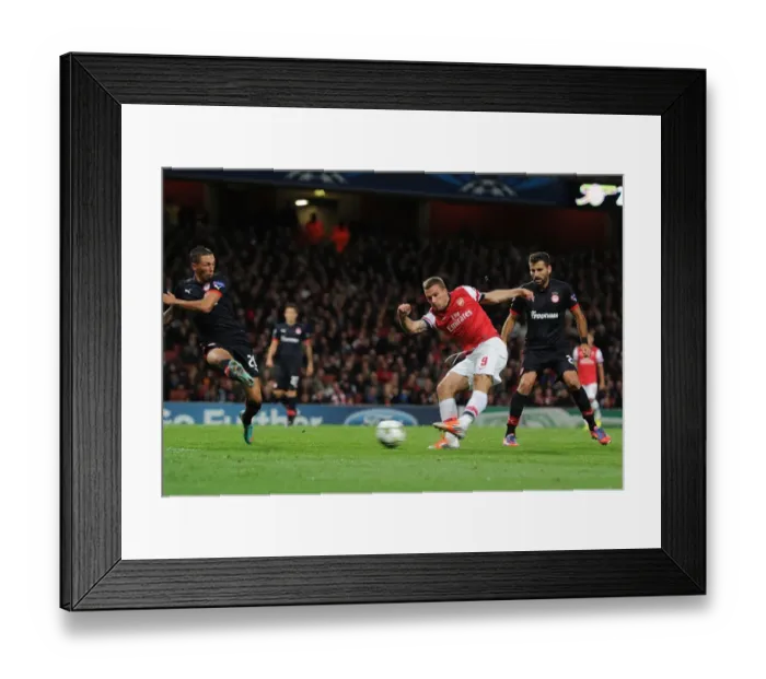 Framed Print : Lukas Podolski Scores the Second Goal for Arsenal in the UEFA Champions League against Olympiacos (2012)
