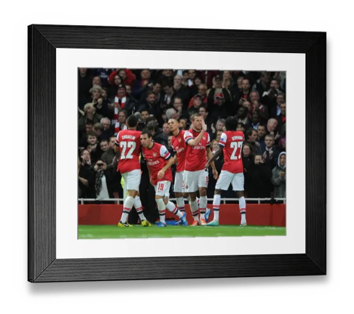 Framed Print : Arsenal's Unstoppable Duo: Podolski and Gervinho Celebrate 2-1 Over Olympiacos in Champions League
