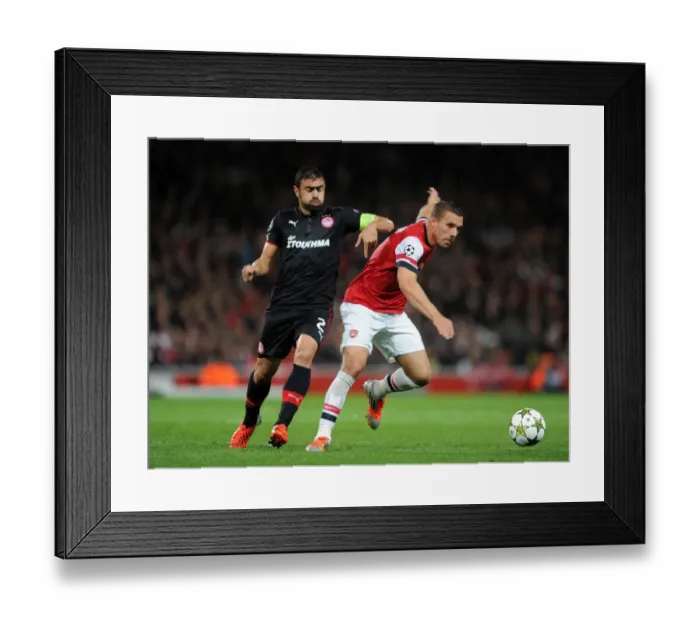 Framed Print : Lukas Podolski (Arsenal) Giannis Maniatis (Olympiacos). Arsenal 3: 1 Olympiacos