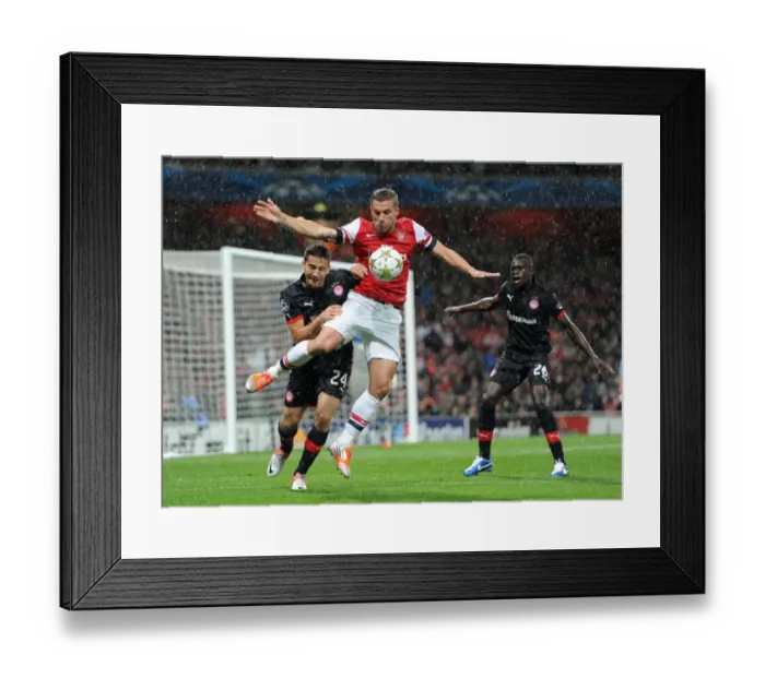 Framed Print : Lukas Podolski's Game-Winning Goal: Arsenal's Triumph over Olympiacos in the Champions League (3-1)
