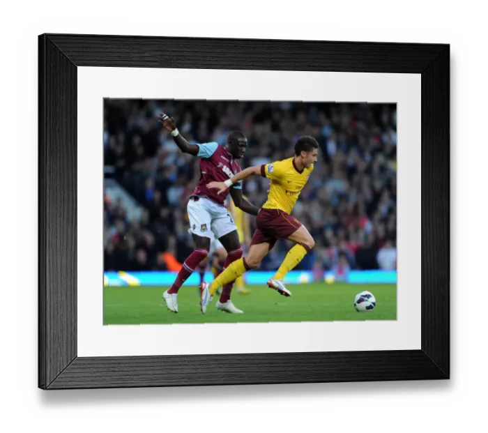 Framed Print : Giroud vs Diame: Battle at the Boleyn Ground - Arsenal vs West Ham United, Premier League 2012-13