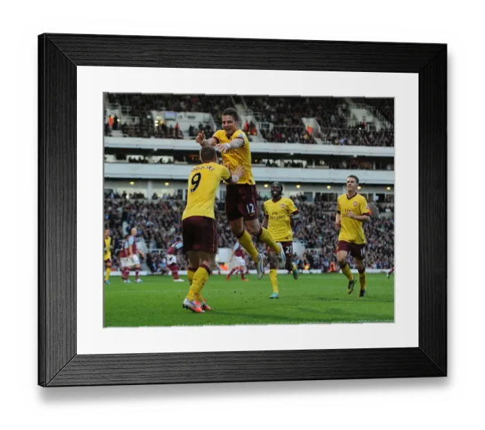 Framed Print : Celebrating Victory: Giroud and Podolski's Goal Connection in Arsenal's 2012-13 Premier League Win Against West Ham United