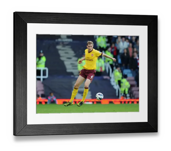 Framed Print : Per Mertesacker Leads Arsenal to Victory: 3-1 over West Ham United, Barclays Premier League