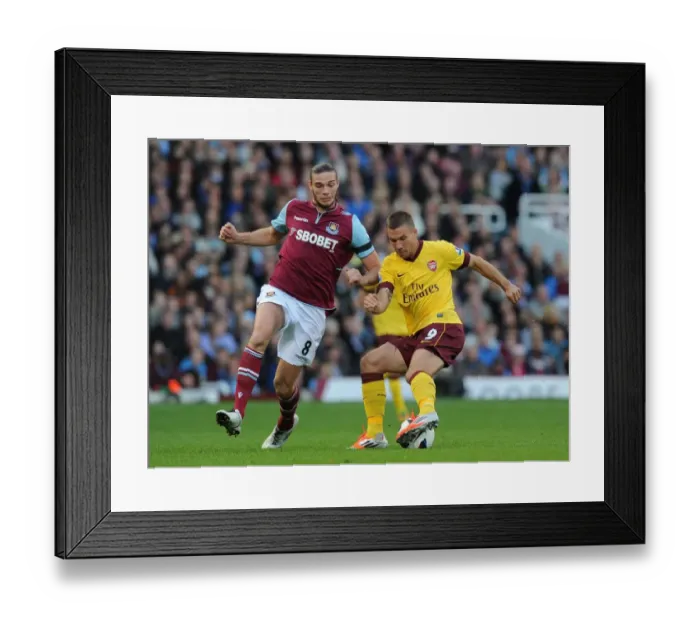 Framed Print : Clash of Titans: Podolski vs. Carroll - West Ham United vs. Arsenal, Premier League 2012-13