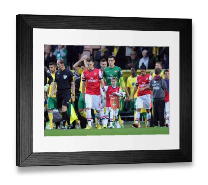 Framed Print : Arsenal mascot walks out with Thomas Vermaelen (Arsenal). Norwich City 1: 0 Arsenal Framed Print : Arsenal mascot walks out with Thomas Vermaelen (Arsenal). Norwich City 1: 0 Arsenal